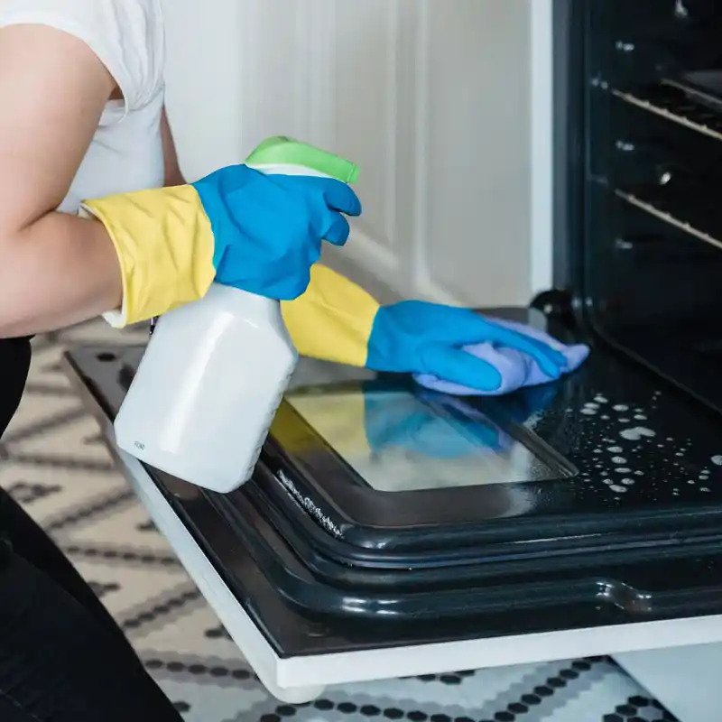 Person cleaning an oven in Leicester
