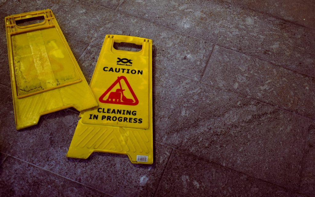 A caution cleaning in progress yellow sign
